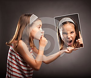 Little girl showing silence gesture