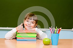 Little girl showing thums up on the background of chalkboard photo