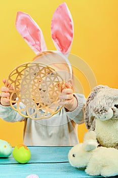 Little girl shows an empty basket for painted Easter eggs for th