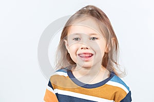Little girl shows myofunctional trainer. dental tariner is made to correct bite photo