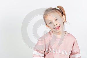 Little girl shows myofunctional trainer. dental tariner is made to correct bite photo