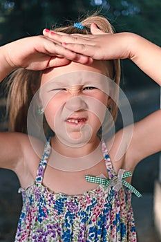 A little girl shows a wobbly baby tooth in her mouth