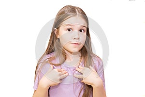The little girl shyly points to herself. Isolated on a white background.