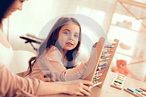 Little girl with Simulator for Counting in Hands.