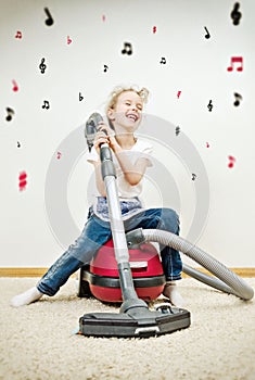 Little girl singing during cleaning the flat.