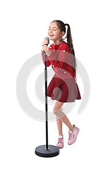 Little girl singing into microphone on white