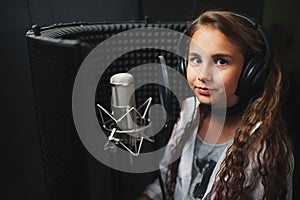 Little girl singing in recording studio