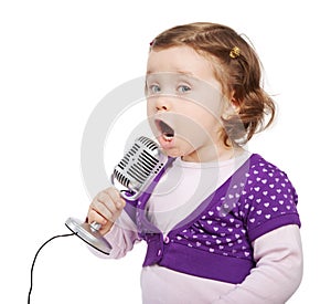 Little girl sings into the microphone.