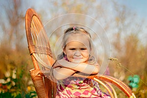Little girl sits on a chair