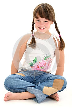 Little Girl Sitting Barefoot on White Floor