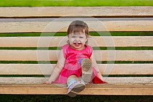 Little girl sitting on bench