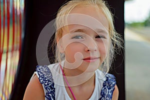 Little girl sitting on the bench