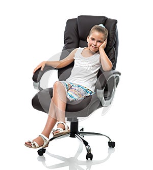 Little girl sitting in big office armchair