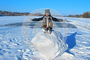 Little Girl Sitting On A Big Snowball.