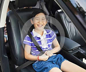 Little girl sitting in the car with seat belt