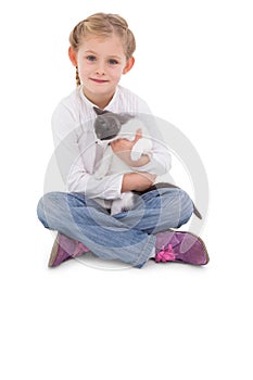 Little girl sitting with cat in her arms