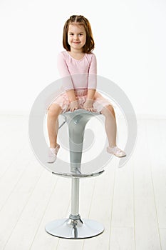 Little girl sitting on chair