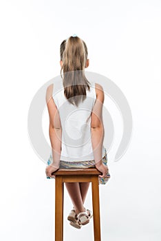 little girl sitting on chair