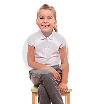 Little girl sitting on a chair and smiling