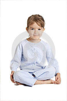 Little girl sitting cross legged