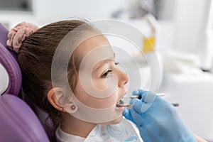 Little girl sitting in the dentists office photo