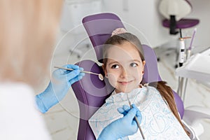 Little girl sitting in the dentists office photo