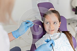 Little girl sitting in the dentists office photo