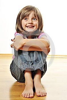 Little girl sitting on a floor