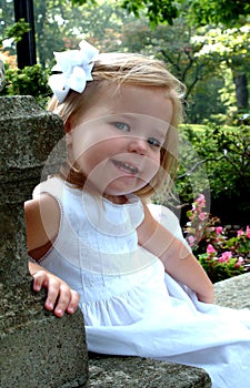 Little Girl Sitting in Garden