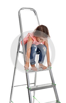 Little girl sitting on ladder on white background.  at home