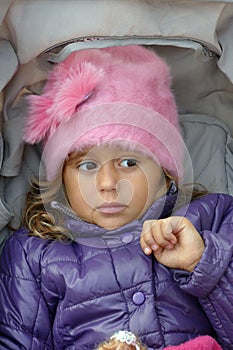 Little girl sitting in a stroller