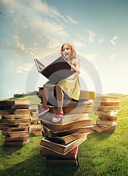 Little Girl sitting on the tower made of big books