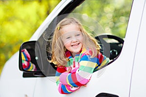 Little girl sitting in white car