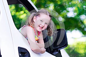 Little girl sitting in white car
