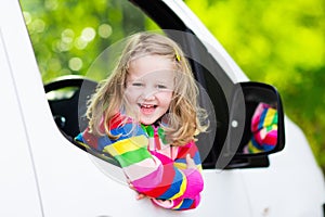 Little girl sitting in white car