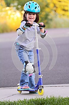 Little girl on skate scooter