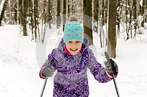 Little girl skiing in winter