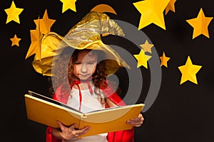 Little girl in sky watcher costume reading book