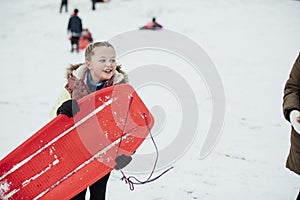 Little Girl with Sled in the Snow