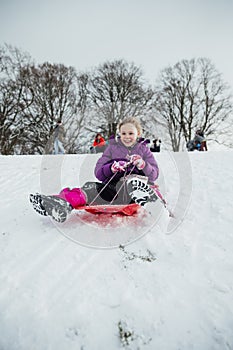 Little Girl Sledding Downhill