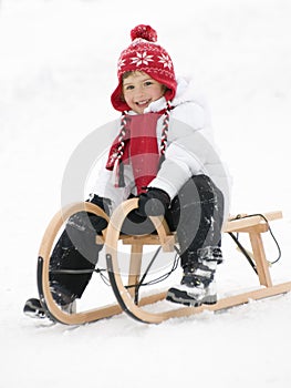 Little girl on sledge