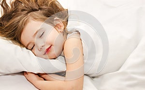 Little girl sleep in the bed close-up