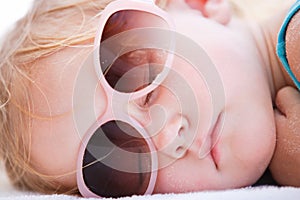 Little girl sleeping at beach