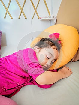 LIttle girl sleeping on the bed with cute face