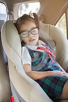 A little girl sleeping in the carseat photo