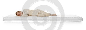 Little girl sleeping on comfortable mattress against white background