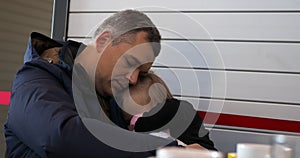 Little girl sleeping in father hands at the airport