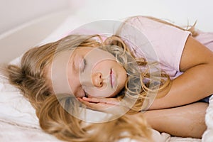 Little girl is sleeping in her bed on a pillow, a sweet calm sleep of a child