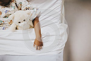 Little girl sleeping in a hospital bed photo