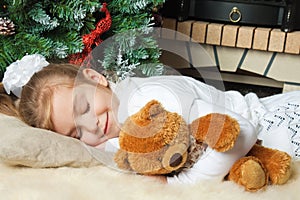 Little girl sleeping and hugging her teddy bear